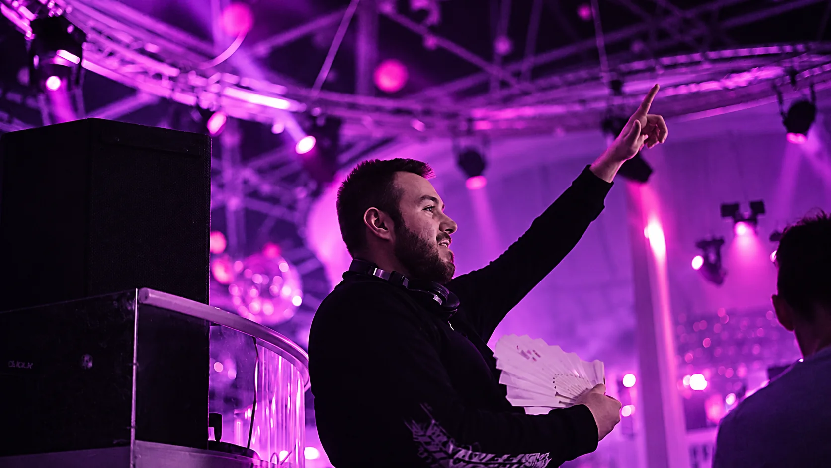 Paulyy Pudd raising an arm towards an Ibiza crowd
